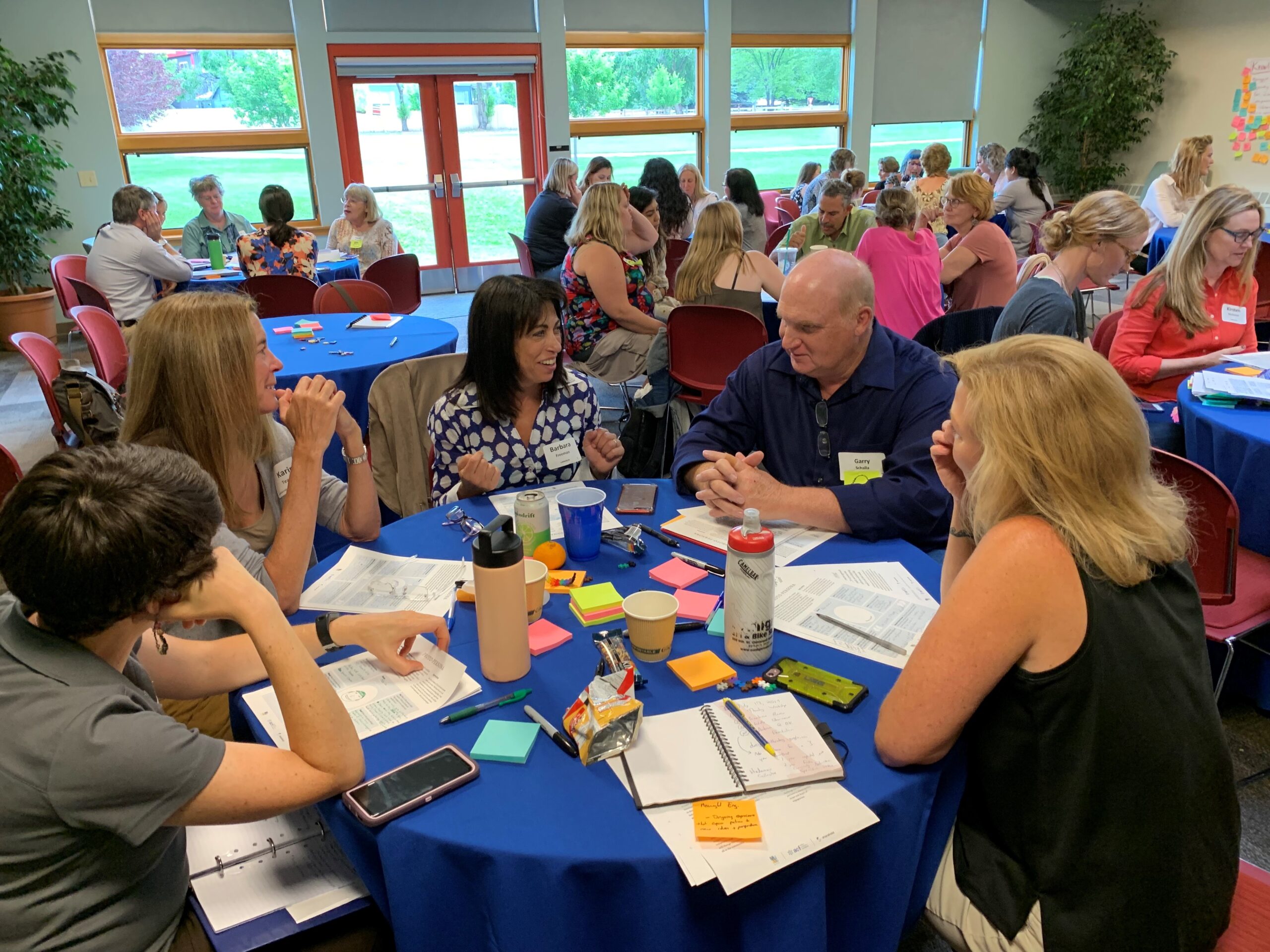 A group of individuals at a round table at learning workshop for philanthropists.