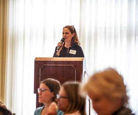 Tamara Tormohlen addressing grant winners at a podium.